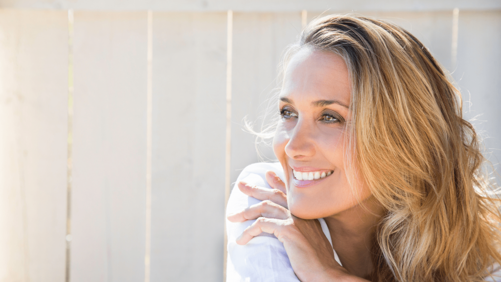 Smiling woman looking relaxed and happy.