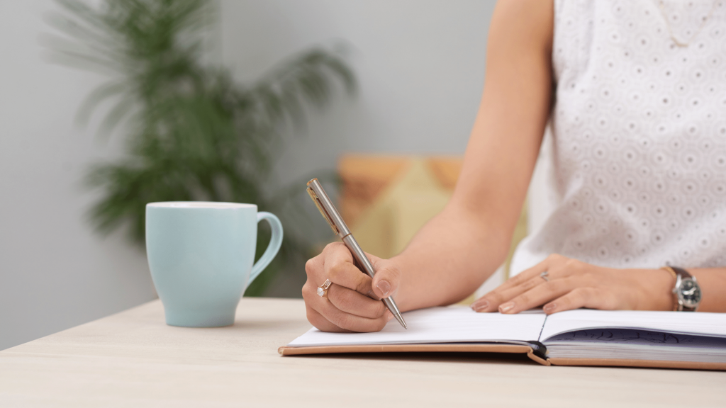 woman with coffee writing